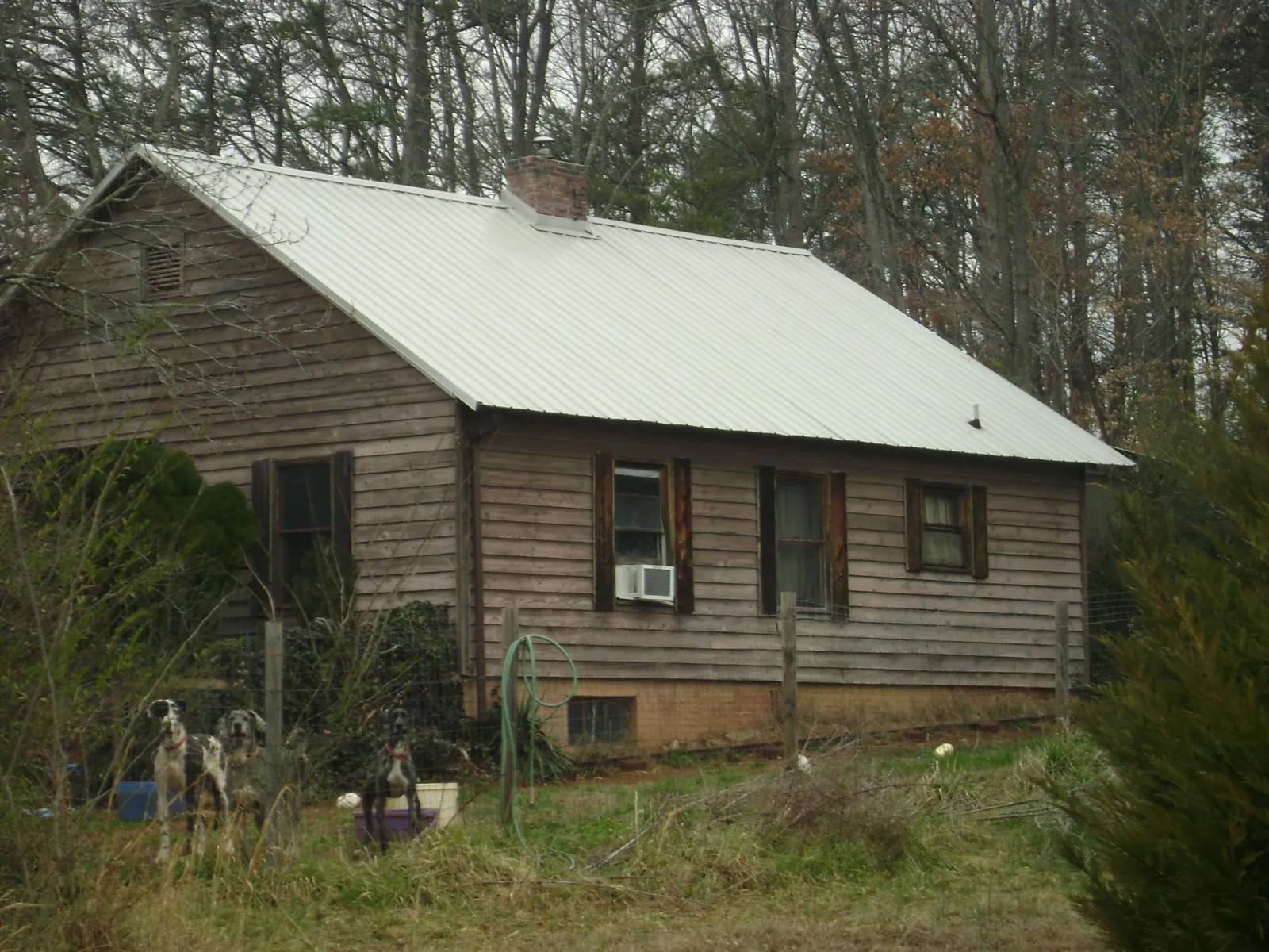 White metal roof on an old wood sided farmhouse, from a Asphalt Shingle Roof Repair job in Oskaloosa